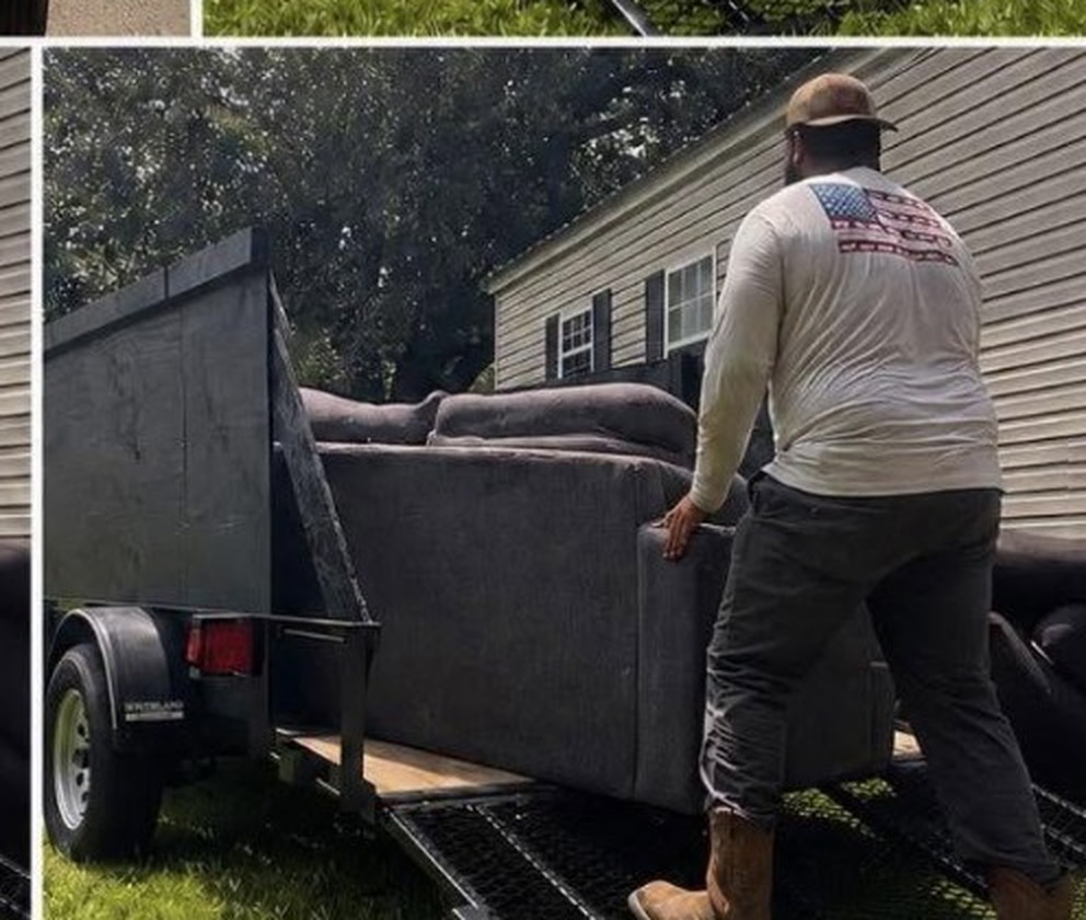 JunkAway loading a sofa onto the trailer